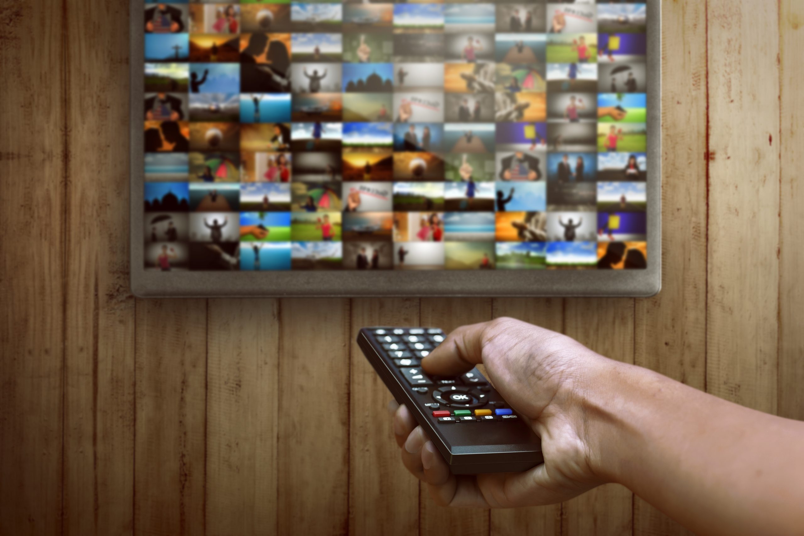 smart tv hand pressing remote control scaled